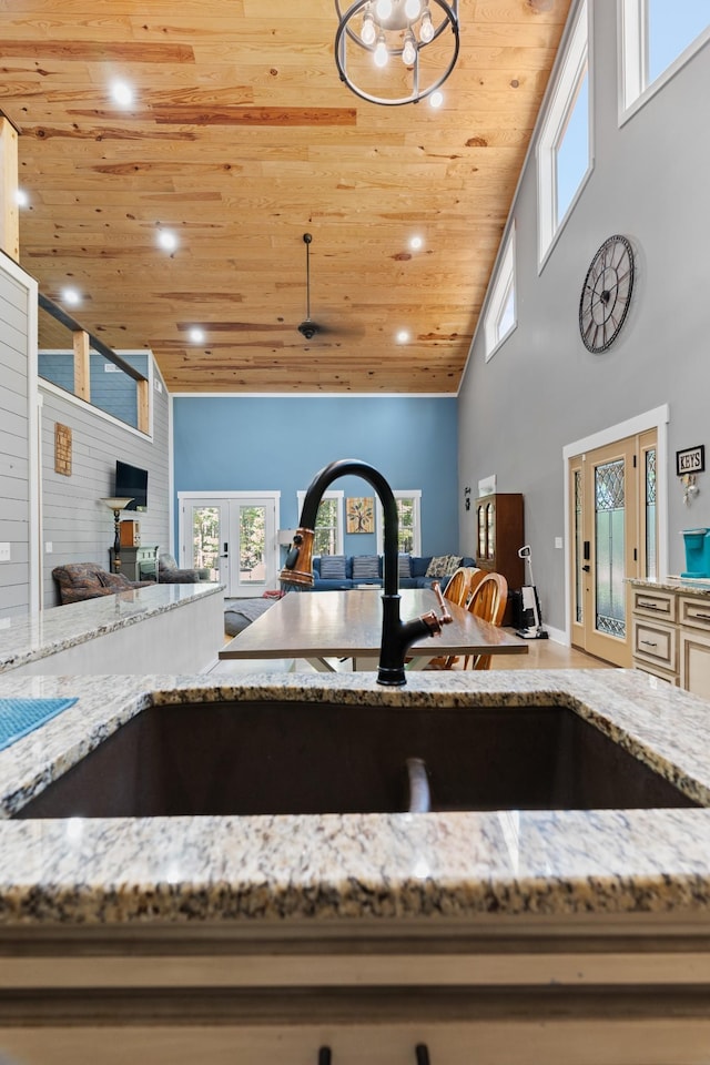 room details with light stone counters, wood ceiling, sink, and french doors