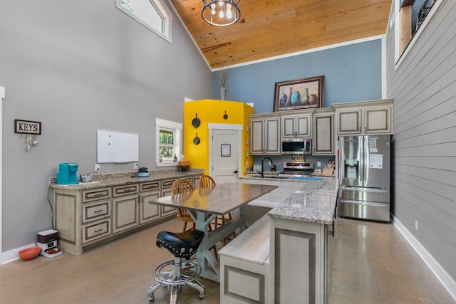 kitchen featuring light stone counters, wood ceiling, stainless steel appliances, and high vaulted ceiling