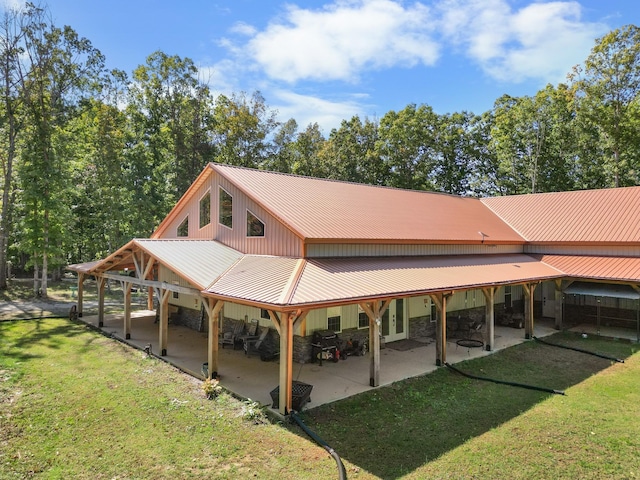 rear view of property with a yard and a patio