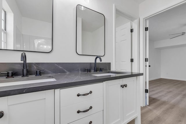 bathroom featuring hardwood / wood-style flooring, ceiling fan, and vanity