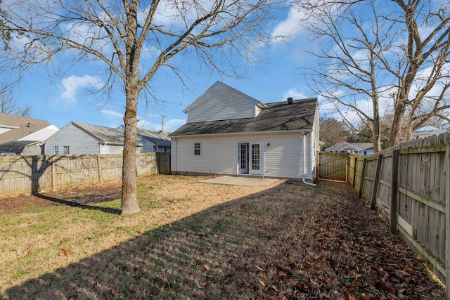 rear view of house with a yard and a patio