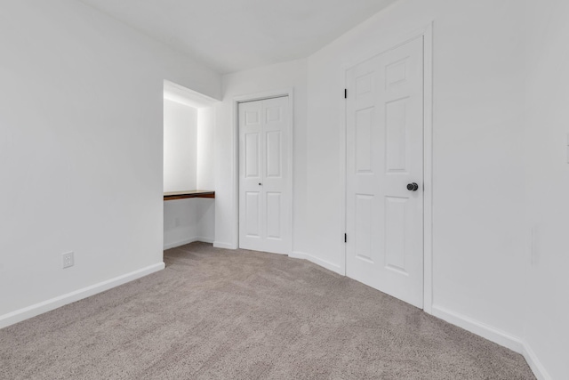 unfurnished bedroom with light colored carpet