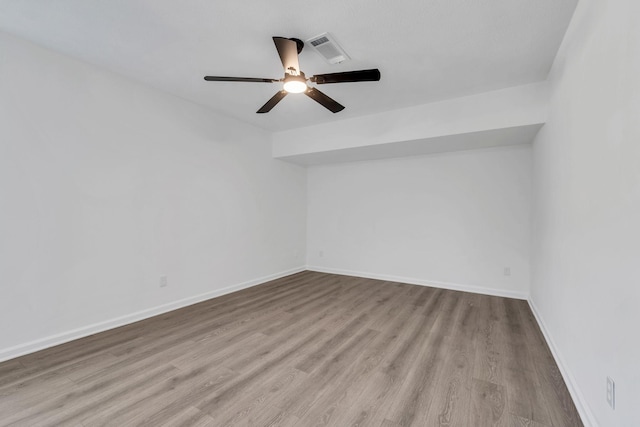 empty room with ceiling fan and light hardwood / wood-style floors