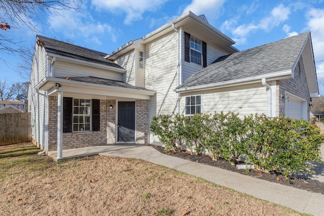 view of front of home featuring a front yard and a garage