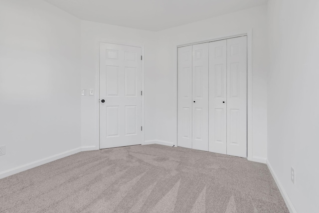 unfurnished bedroom with carpet and a closet