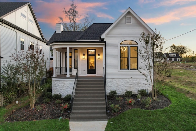 view of front facade featuring a lawn and a porch