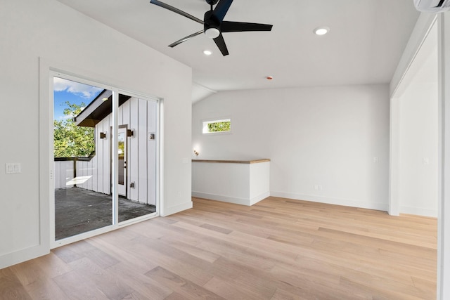 unfurnished room featuring light hardwood / wood-style floors, ceiling fan, a healthy amount of sunlight, and lofted ceiling