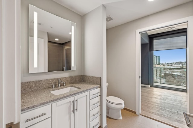 bathroom featuring vanity and toilet