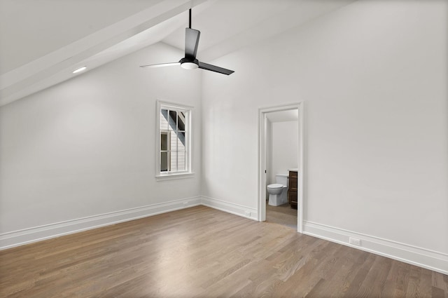 interior space featuring hardwood / wood-style floors, ceiling fan, lofted ceiling, and ensuite bathroom