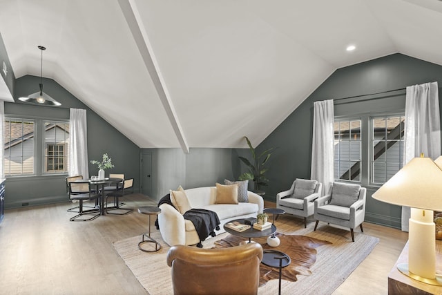 living room featuring light wood-type flooring and lofted ceiling