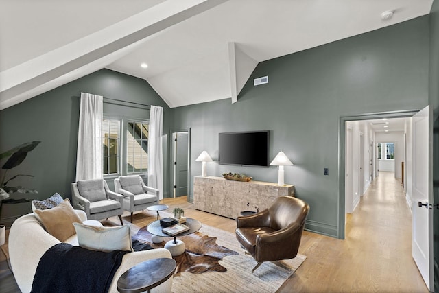 living room featuring light wood-type flooring and lofted ceiling