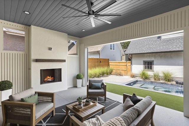 view of patio / terrace with an outdoor living space with a fireplace, pool water feature, and ceiling fan