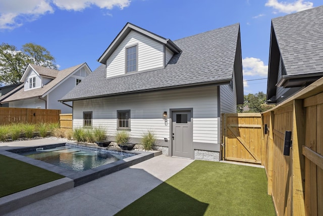 back of property featuring a patio, a fenced in pool, and a lawn