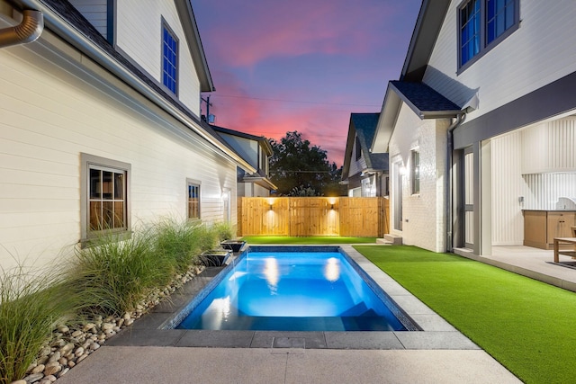 view of pool at dusk