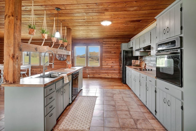 kitchen with wooden ceiling, black appliances, sink, hanging light fixtures, and light tile patterned flooring