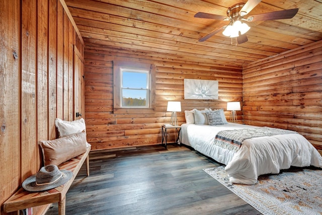 bedroom with ceiling fan, dark hardwood / wood-style flooring, wooden ceiling, and rustic walls