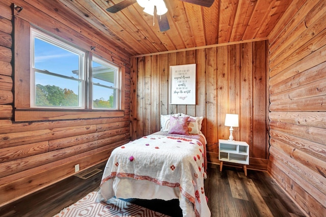 bedroom featuring wooden walls, ceiling fan, dark wood-type flooring, and wood ceiling