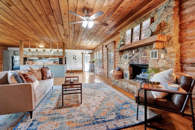 living room with ceiling fan, a fireplace, wooden ceiling, and hardwood / wood-style flooring