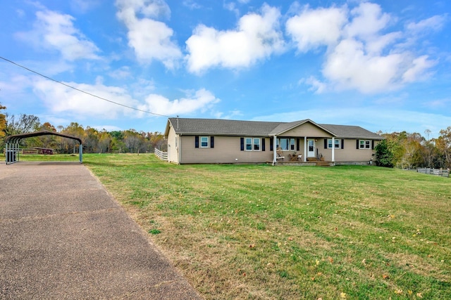 single story home with a front lawn and a carport