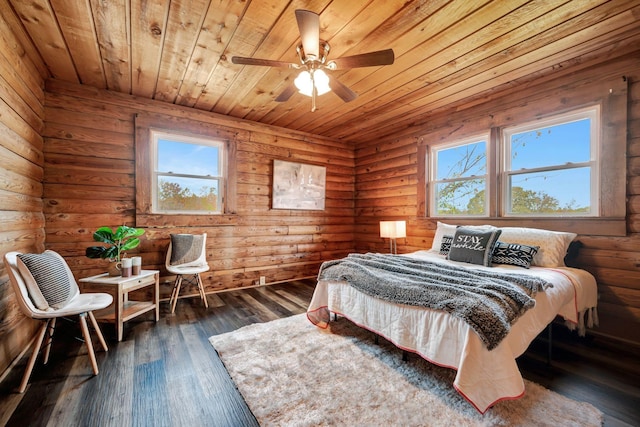 bedroom featuring ceiling fan, dark hardwood / wood-style flooring, and log walls