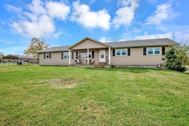 ranch-style home featuring a front lawn, a porch, and a carport