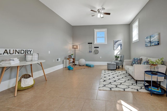 interior space with ceiling fan and light tile patterned flooring