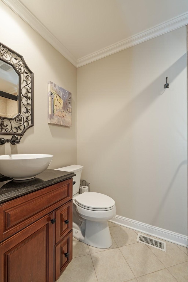 bathroom featuring tile patterned floors, crown molding, vanity, and toilet