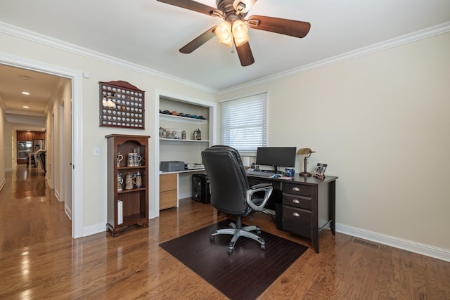 office area featuring ceiling fan, dark hardwood / wood-style floors, built in features, and crown molding