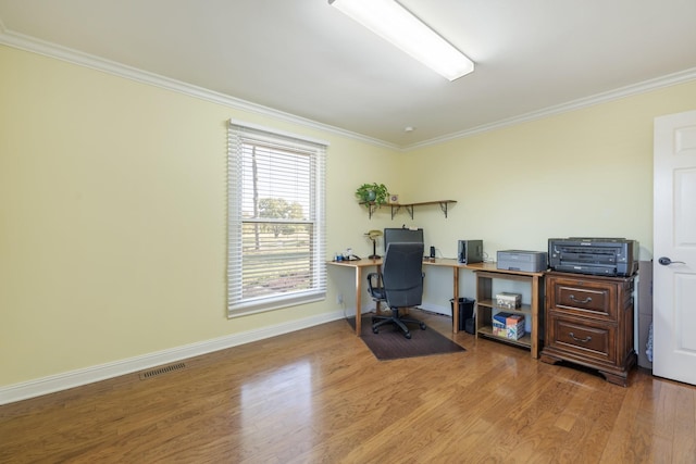 office area with wood-type flooring and ornamental molding