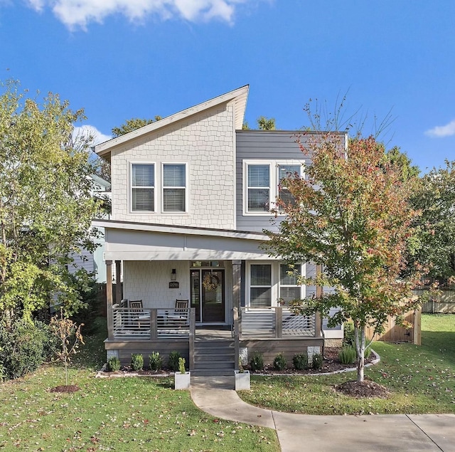 view of front of home featuring covered porch and a front yard