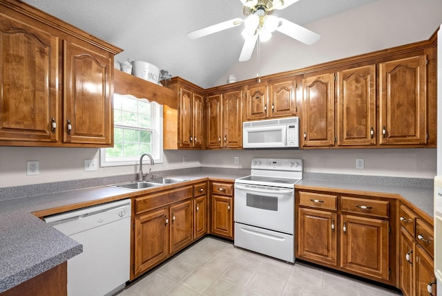 kitchen featuring white appliances, vaulted ceiling, ceiling fan, and sink