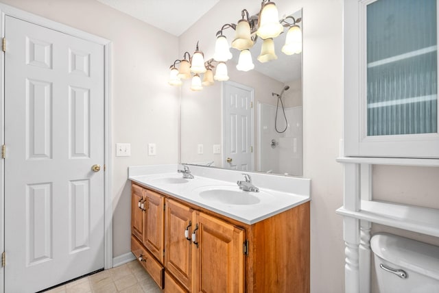 bathroom with a shower, toilet, vanity, and a notable chandelier