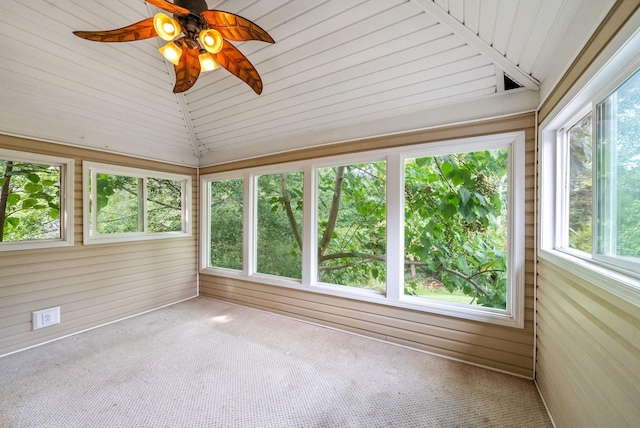 unfurnished sunroom with ceiling fan, a healthy amount of sunlight, and vaulted ceiling