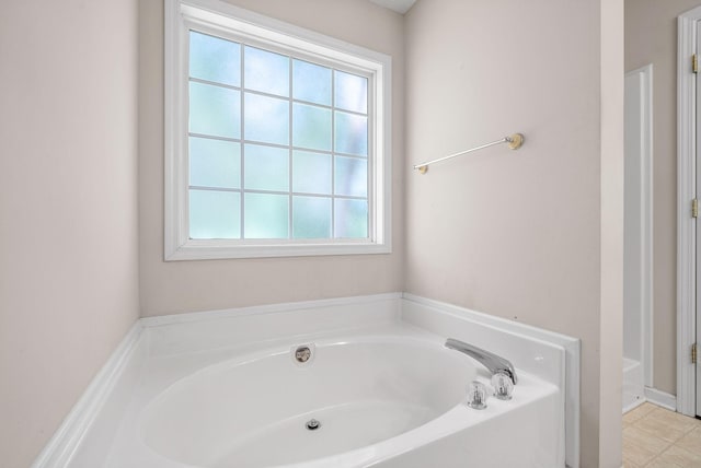 bathroom with plenty of natural light and a bathing tub