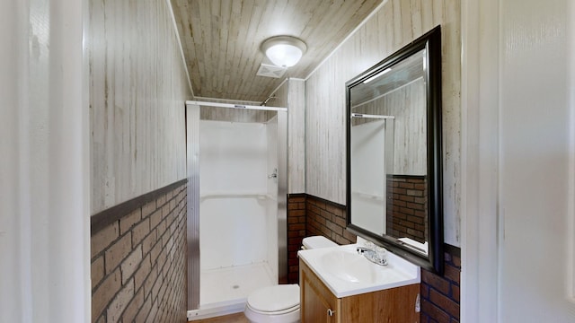 bathroom featuring toilet, a shower, wooden walls, and vanity