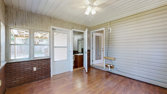 unfurnished sunroom featuring ceiling fan