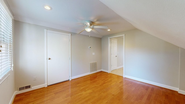 additional living space with lofted ceiling, ceiling fan, and hardwood / wood-style floors