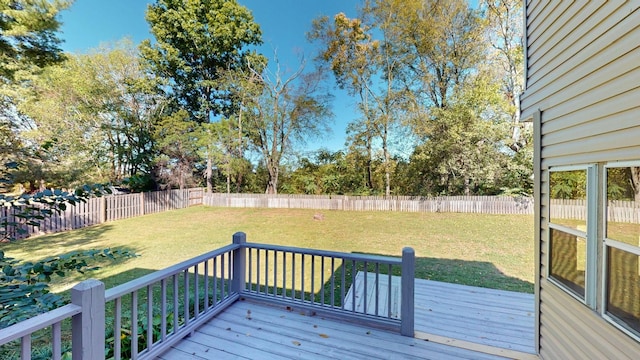 wooden deck featuring a lawn