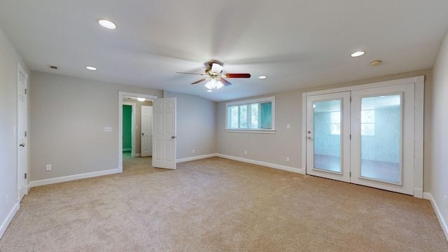 carpeted spare room with ceiling fan