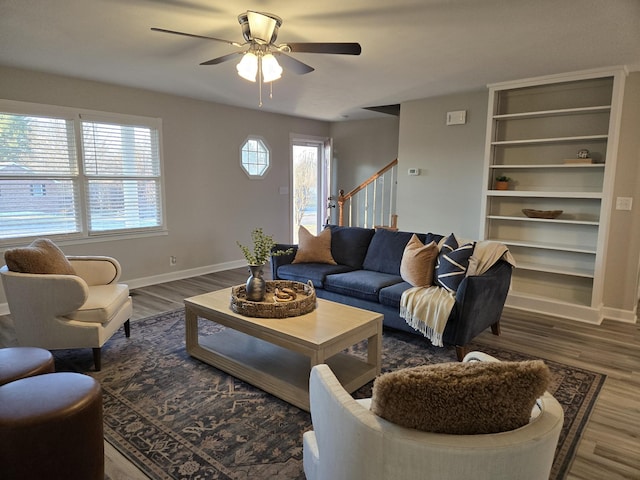 living room with ceiling fan and dark hardwood / wood-style flooring