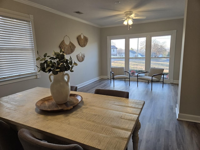 dining area featuring dark hardwood / wood-style flooring, ornamental molding, and ceiling fan