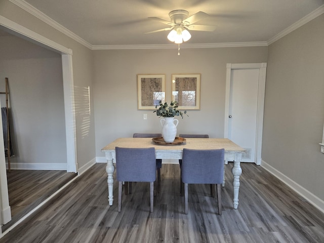 dining area with ceiling fan, crown molding, and dark wood-type flooring