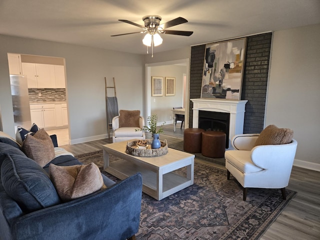 living room with ceiling fan and dark hardwood / wood-style floors