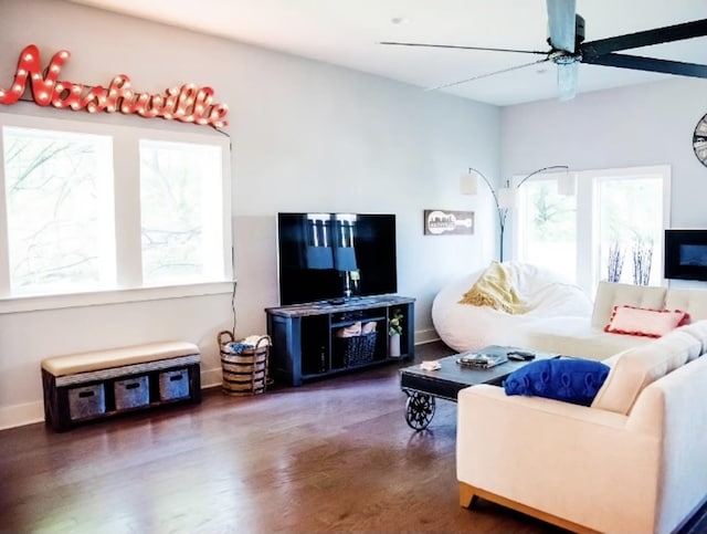 living room featuring dark wood-type flooring and ceiling fan