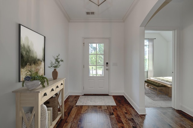 doorway to outside featuring ornamental molding and dark wood-type flooring