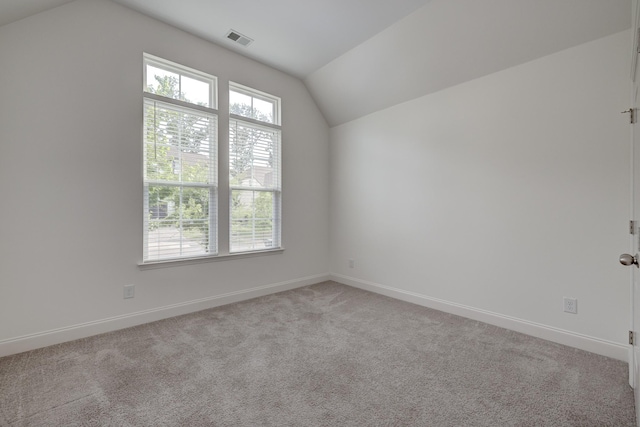 bonus room with light carpet and lofted ceiling