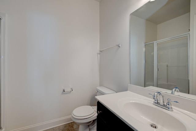 bathroom with a shower with door, vanity, and toilet