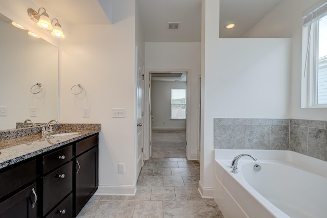 bathroom with a bathtub and vanity