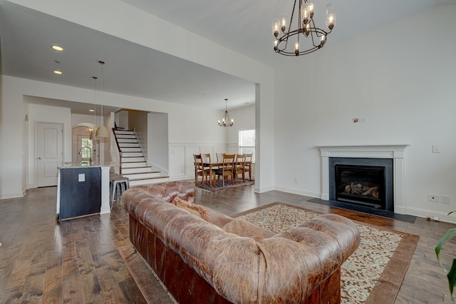 living room with dark wood-type flooring and a chandelier