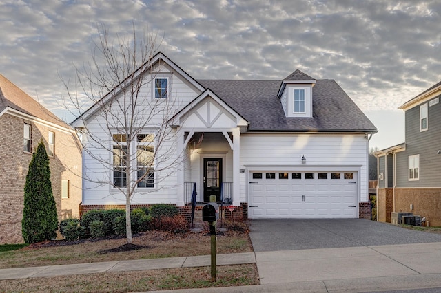 view of front of house with central AC unit and a garage